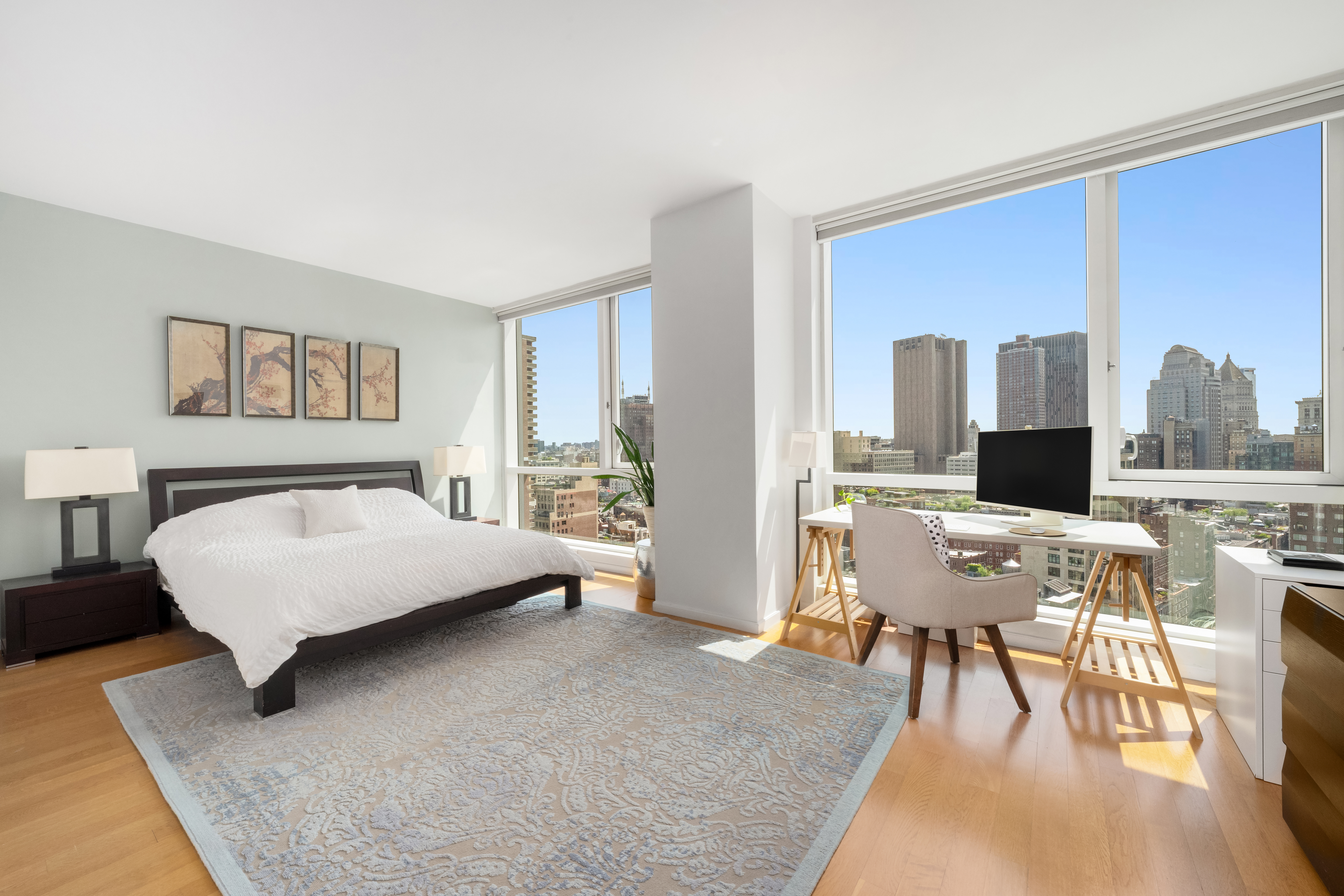 200 Chambers Street, Unit 25F Manhattan, NY 10007 - Photo 8 of 14 a living room with furniture and a flat screen tv