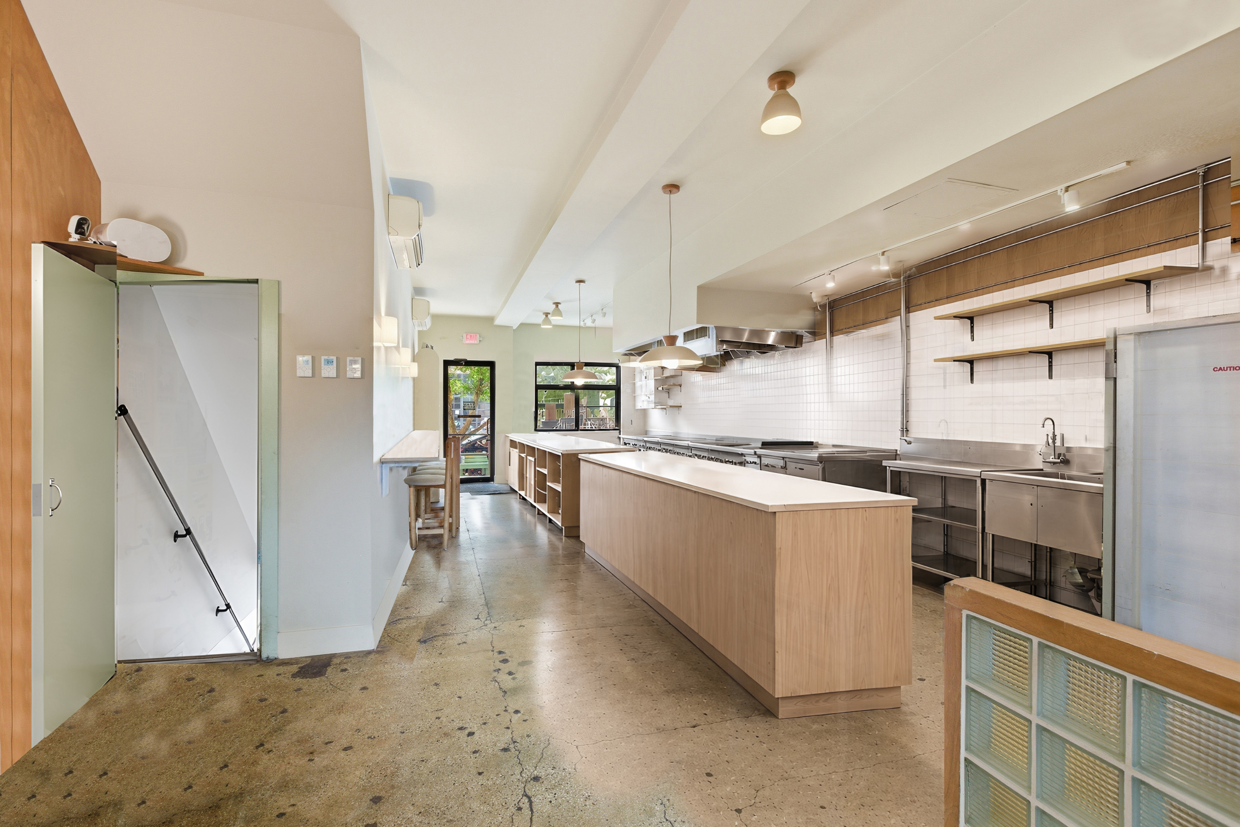 29 Greenpoint Avenue Brooklyn, NY 11222 - Photo 5 of 18 a large white kitchen with a stove a refrigerator and a fireplace