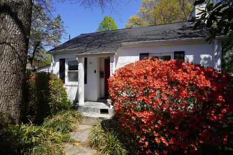 a front view of a house with plants