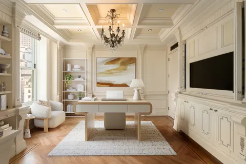 a living room with furniture a chandelier and a flat screen tv