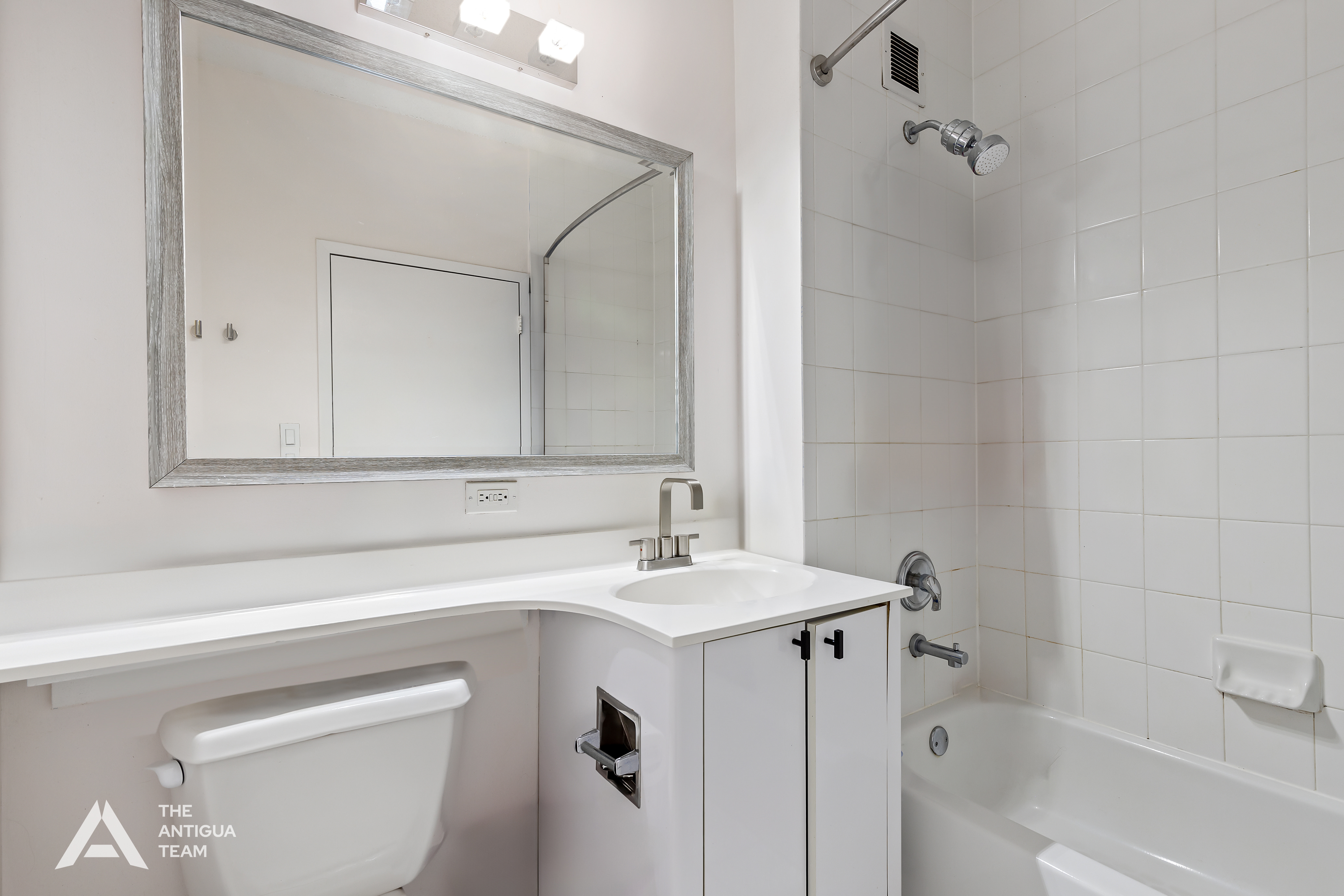 60 Oceana Drive West, Unit 10A Brooklyn, NY 11235 - Photo 6 of 16 a bathroom with a sink a toilet and shower