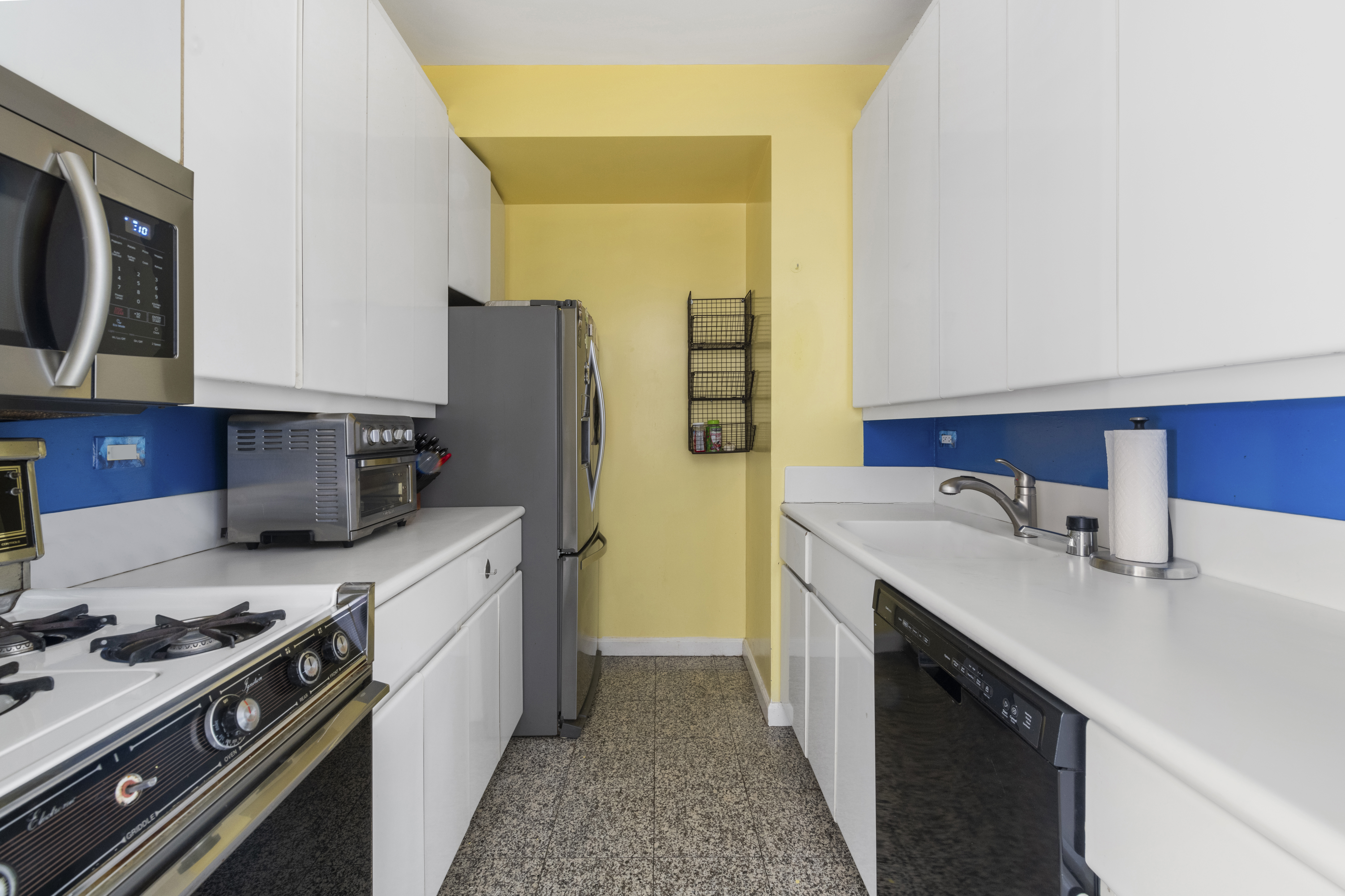 530 East 76th Street Manhattan, NY 10021 - Photo 12 of 20 a kitchen with stainless steel appliances granite countertop a sink stove and refrigerator