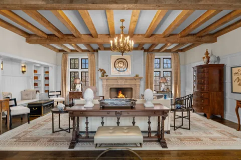 a view of a dining room with furniture and a chandelier