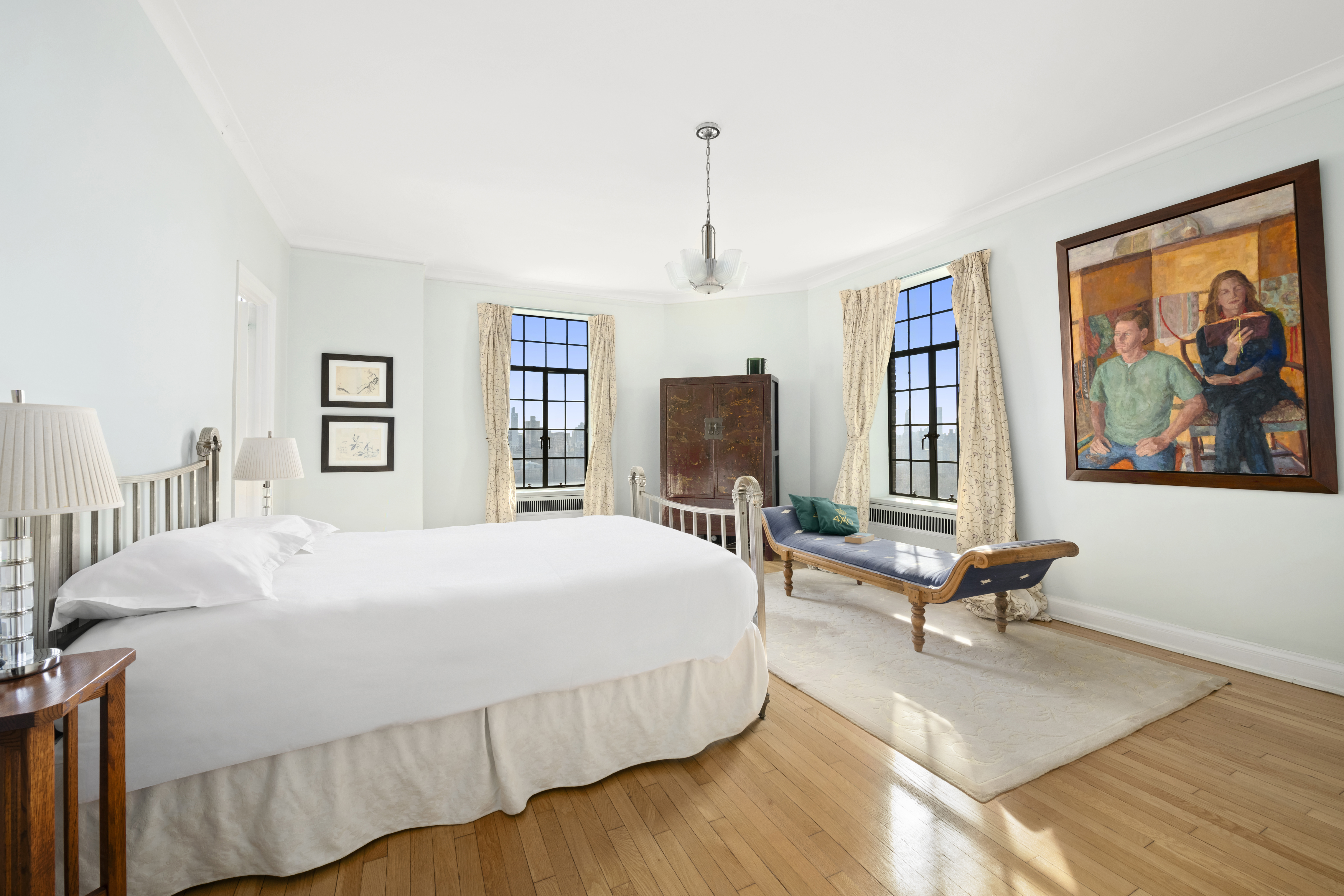 300 Central Park West, Unit 21G Manhattan, NY 10024 - Photo 11 of 21 a bedroom with a large bed a chandelier and windows