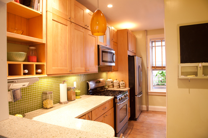 2022 Beverley Road, Unit 7 Brooklyn, NY 11226 - Photo 4 of 10 a kitchen with stainless steel appliances a refrigerator a sink a stove top oven and wooden floor