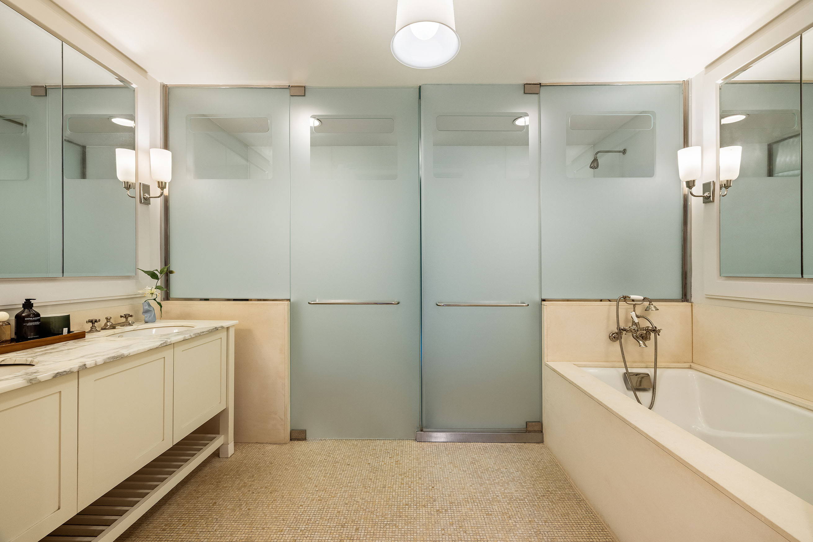 92 Laight Street, Unit 6D Manhattan, NY 10013 - Photo 10 of 15 a bathroom with a tub sink and mirror