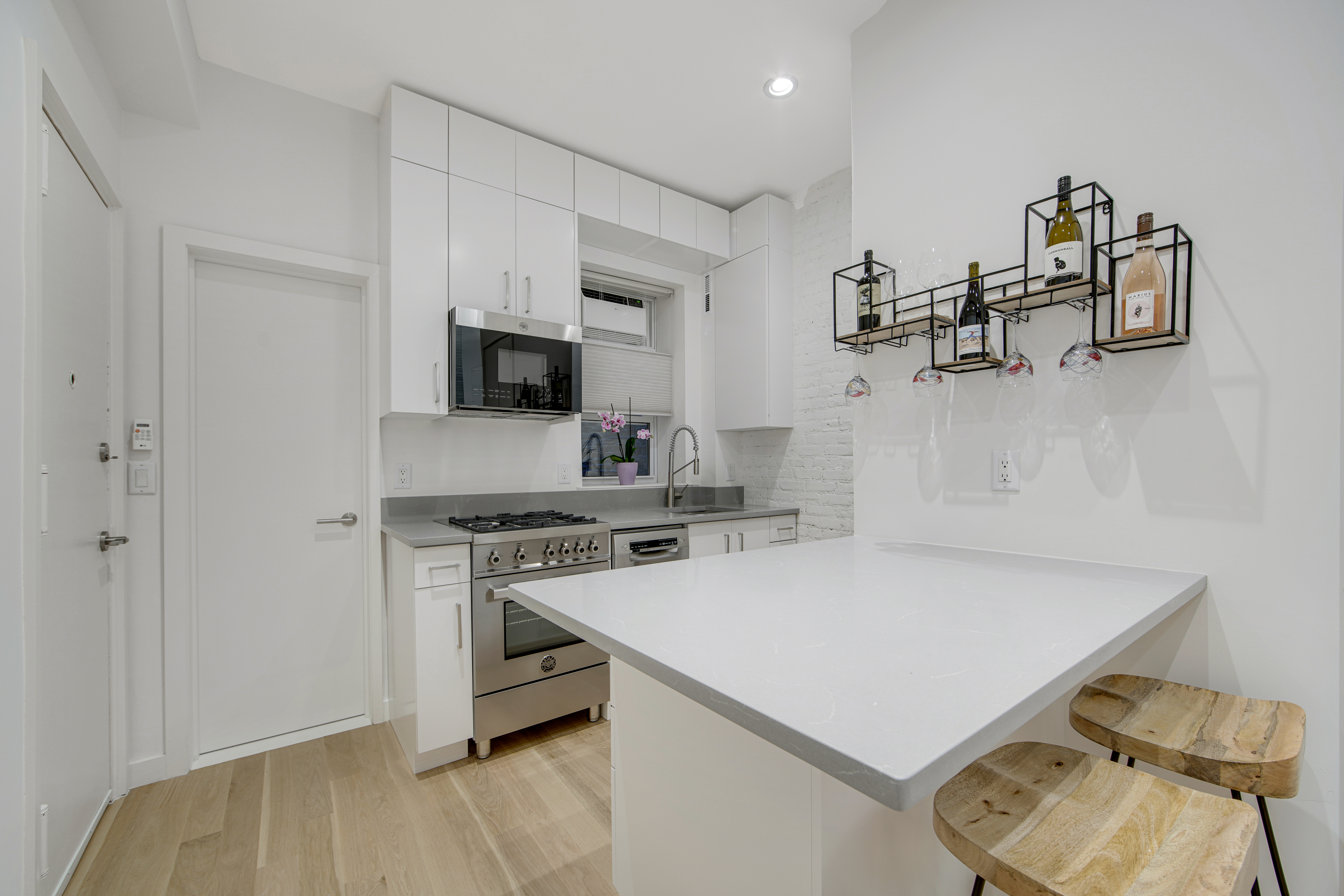 214 West 16th Street, Unit 1W Manhattan, NY 10011 - Photo 4 of 13 a kitchen with a stove a sink and a refrigerator