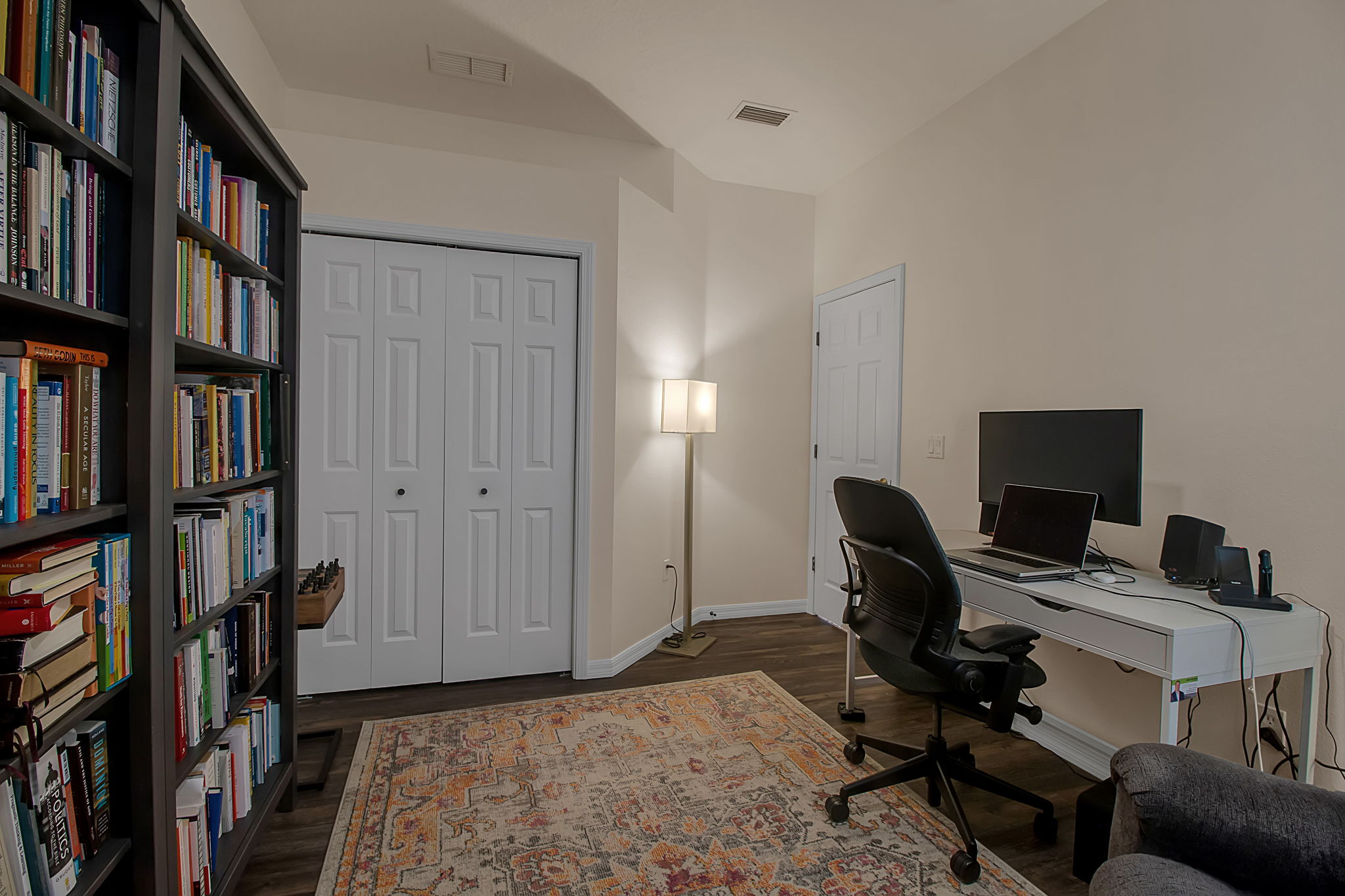 6106 34th Court East Bradenton, FL 34203 - Photo 44 of 69 a view of a workspace with furniture and a book shelf