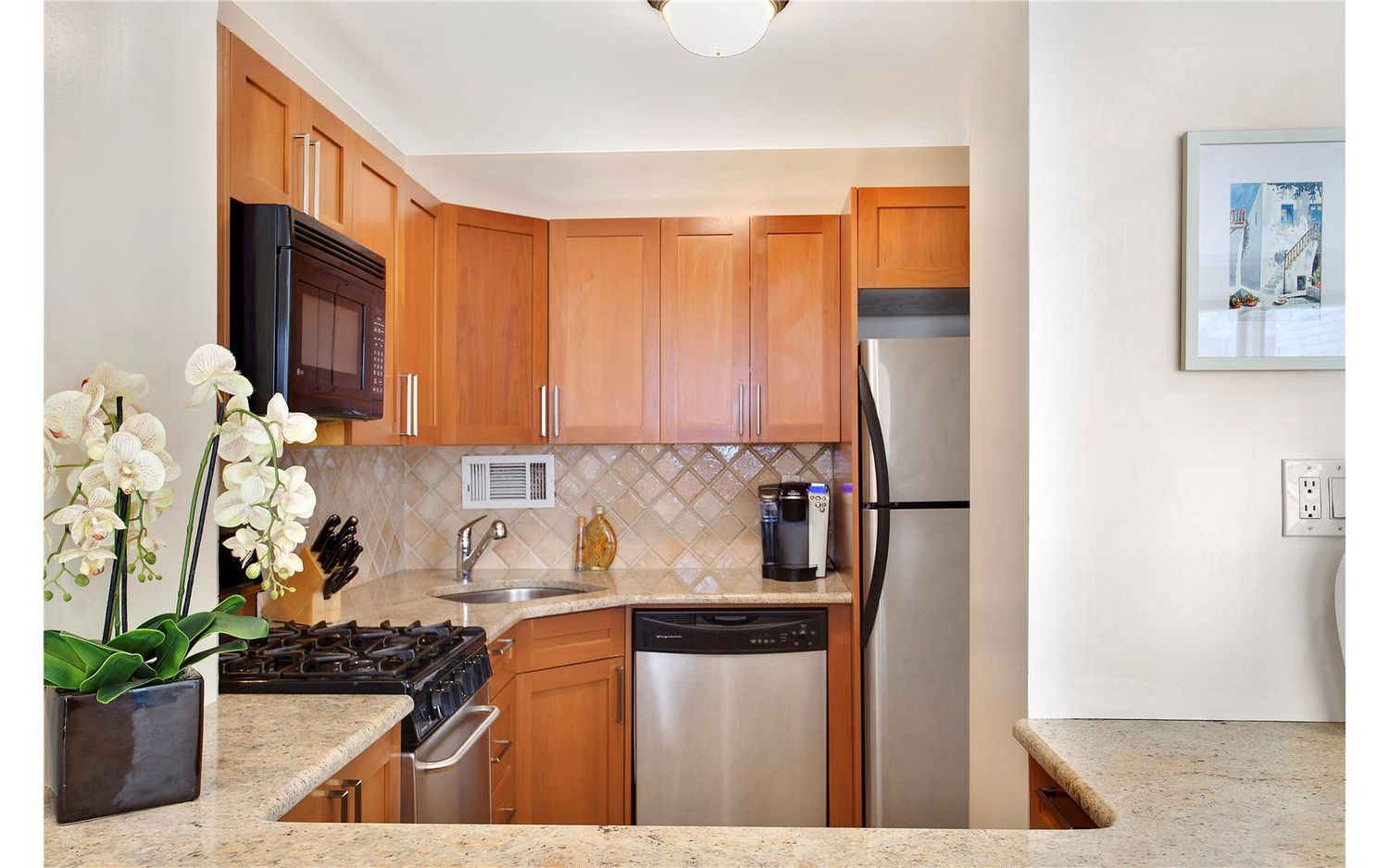 333 East 34th Street, Unit 5L Manhattan, NY 10016 - Photo 6 of 8 a kitchen with stainless steel appliances granite countertop a refrigerator and a stove top oven