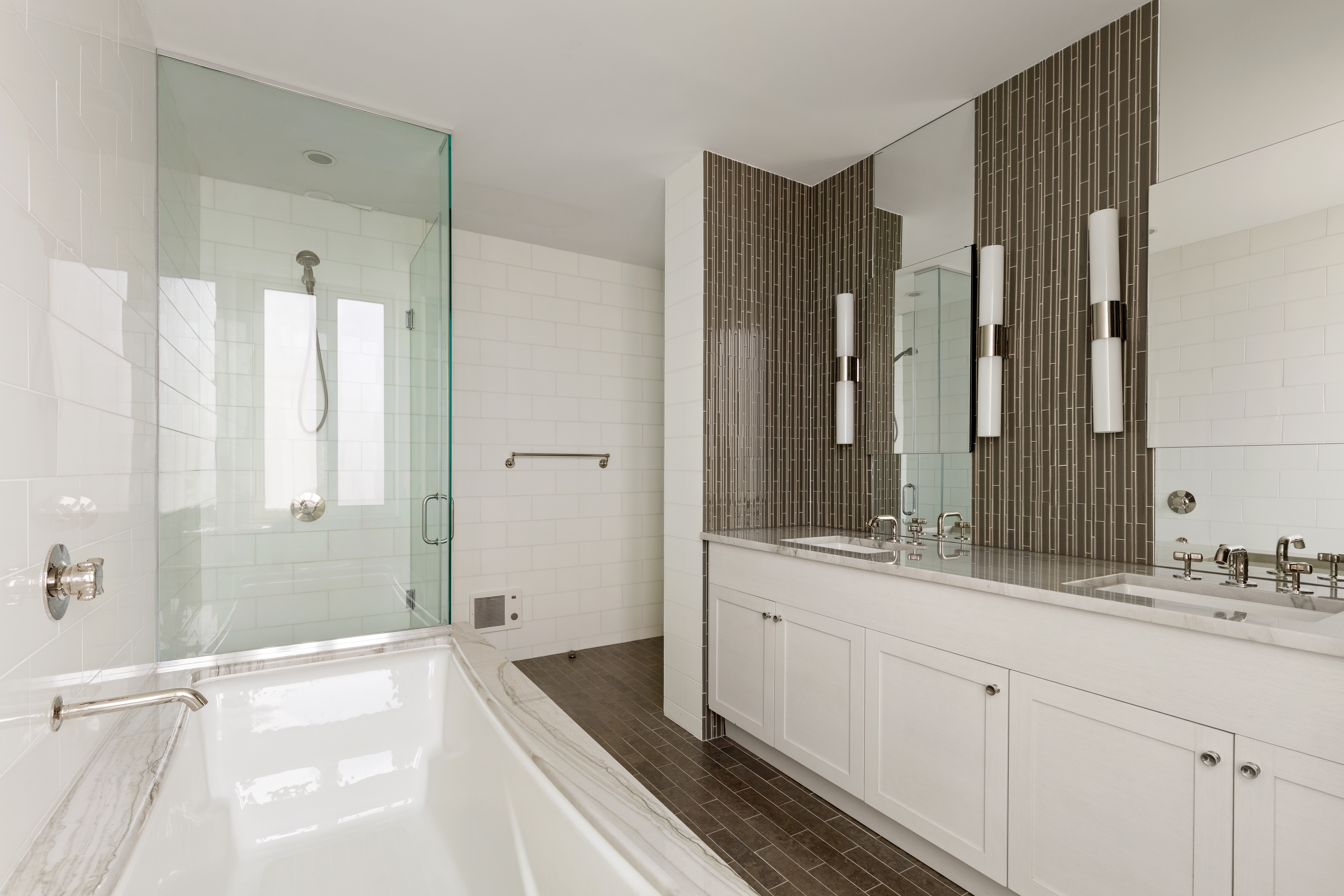 230 West 78th Street, Unit 18A Manhattan, NY 10024 - Photo 7 of 14 a spacious bathroom with a double vanity sink a large mirror a bathtub and shower