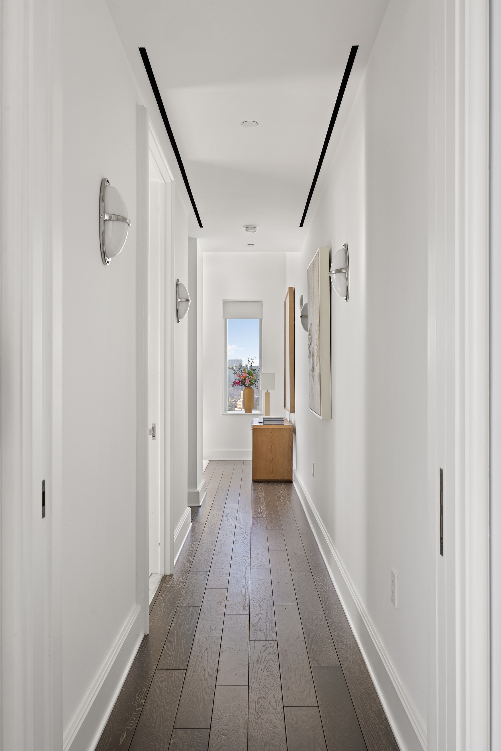 45 East 22nd Street, Unit 32B Manhattan, NY 10010 - Photo 19 of 36 a view of a hallway view with wooden floor and staircase