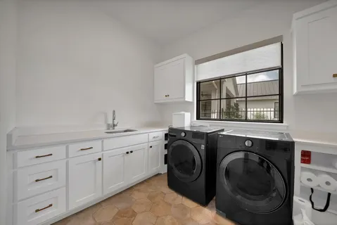 a utility room with sink dryer and washer