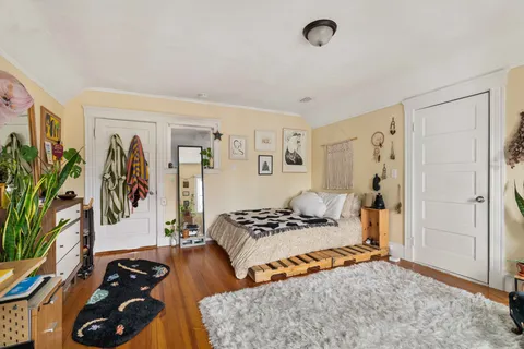 a bedroom with a bed and a couch