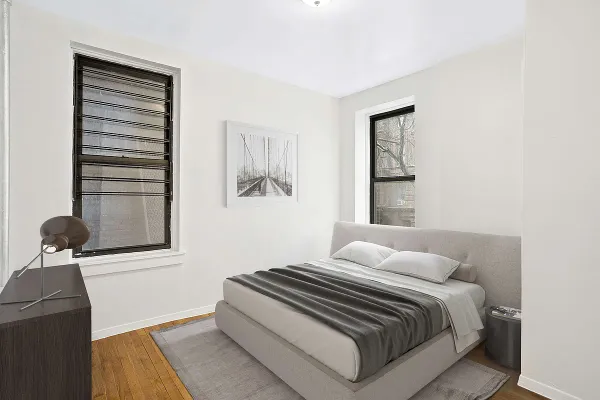 a bedroom with a bed and a window