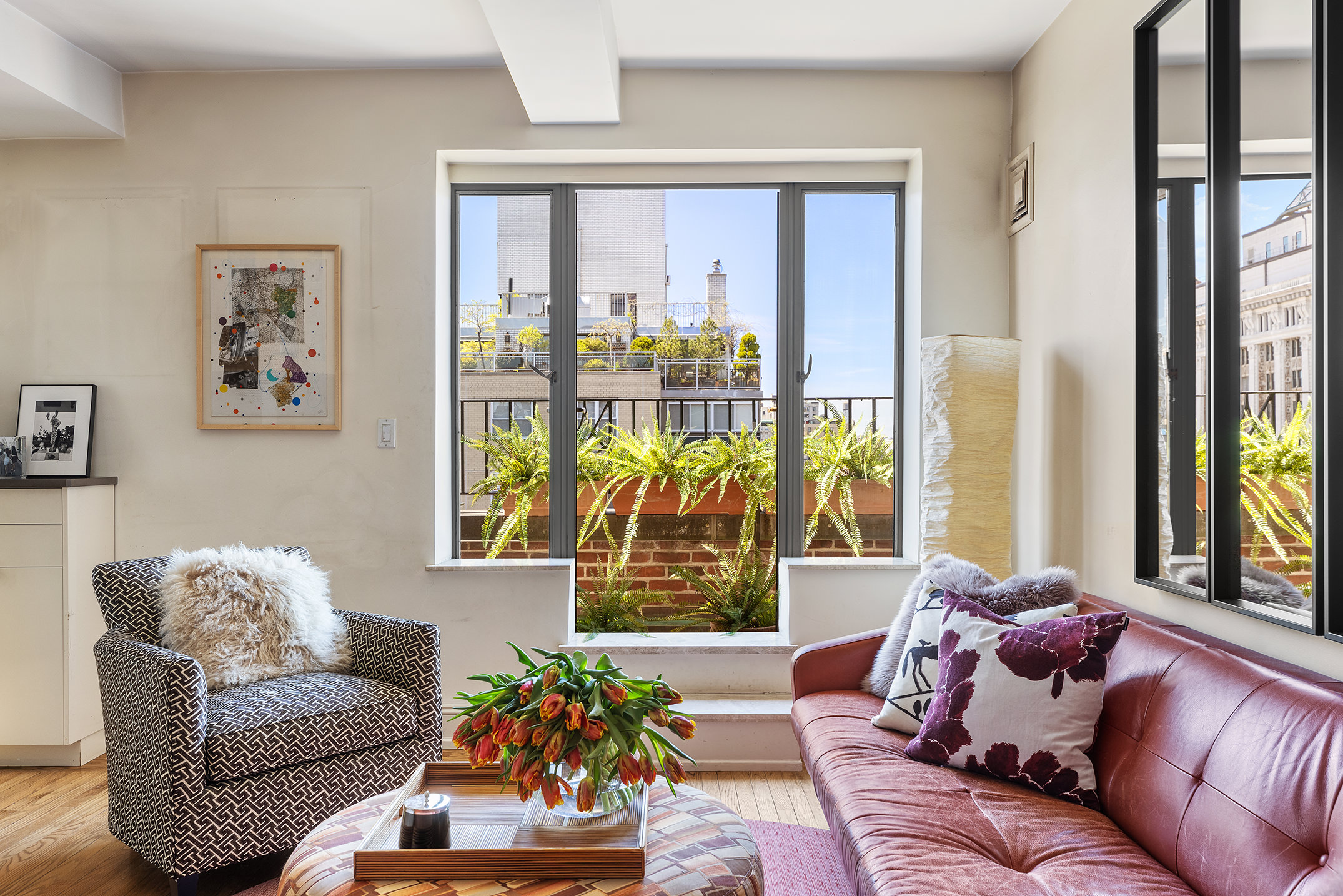 200 East 16th Street, Unit 19D Manhattan, NY 10003 - Photo 3 of 14 a living room with furniture and a large window