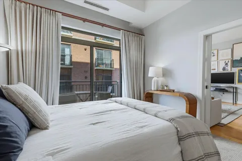 a bedroom with a large bed and a flat screen tv