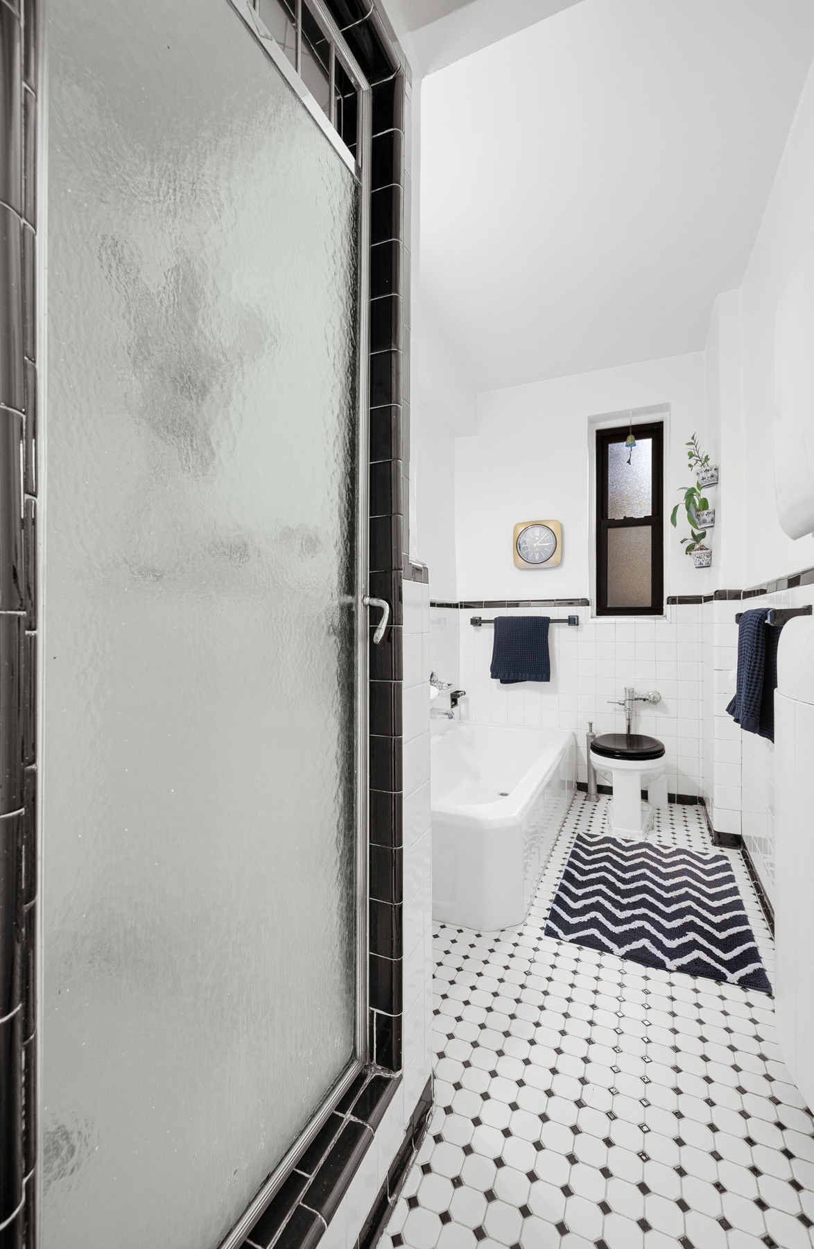 77-11 35th Avenue, Unit 3N Queens, NY 11372 - Photo 13 of 21 a bathroom with a bathtub and shower