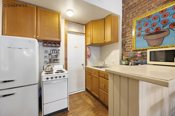 a kitchen with stainless steel appliances a stove a sink and a refrigerator