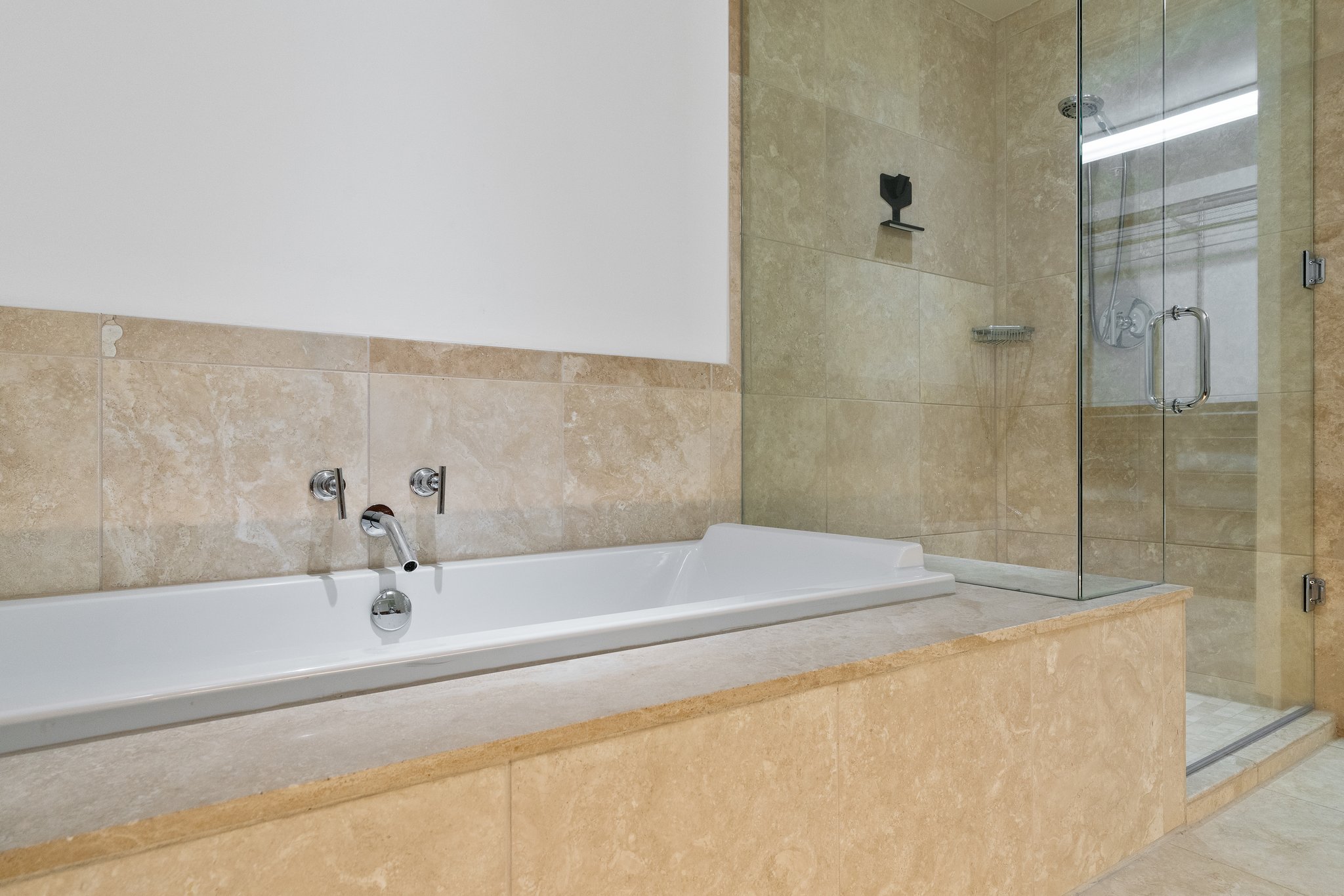 210 Lee Barton Drive, Unit 517 Austin, TX 78704 - Photo 20 of 32 a bathroom with a bathtub and shower