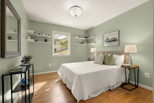 a bedroom with a bed and a potted plant