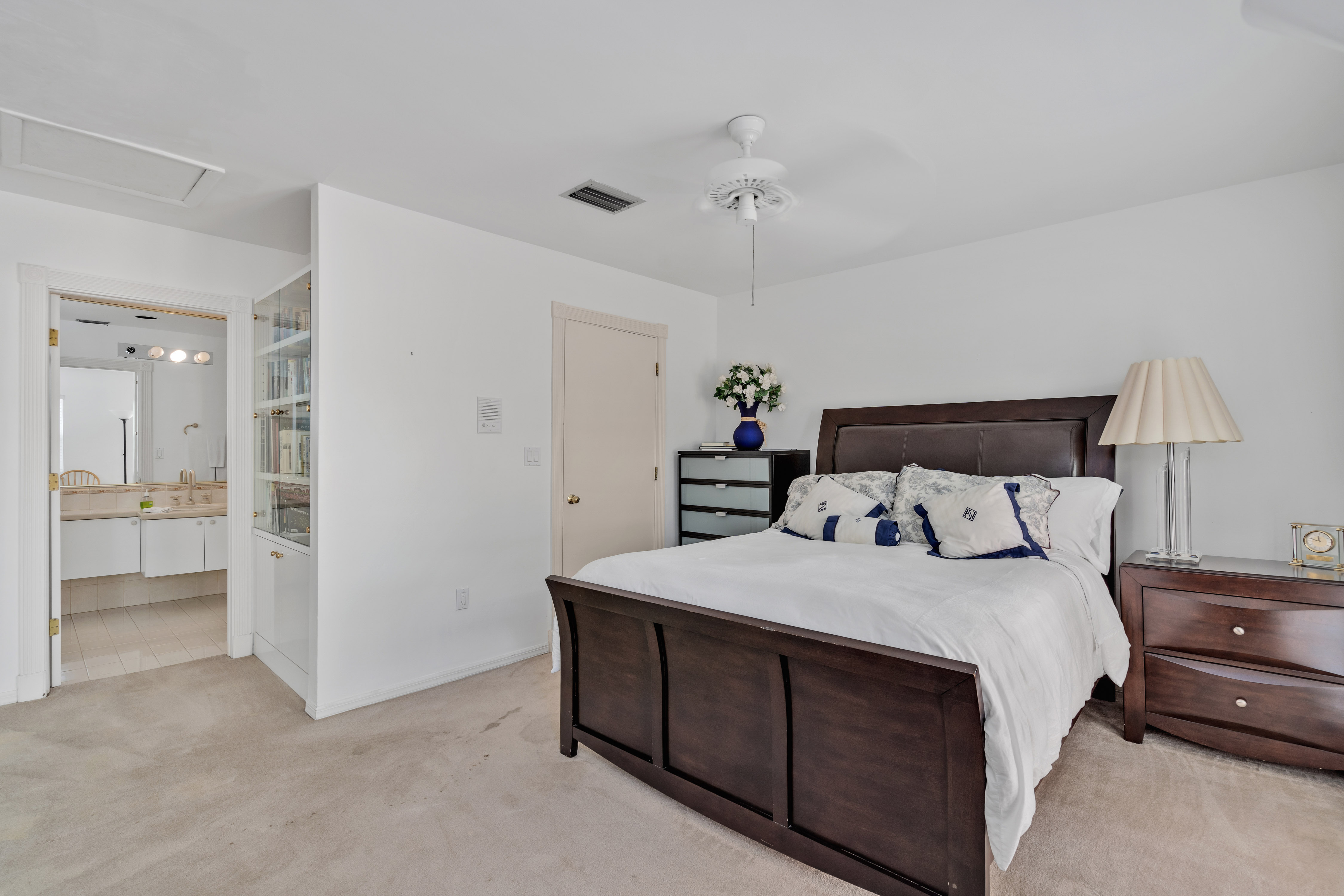 8768 Southwest 62nd Court Miami, FL 33156 - Photo 24 of 56 a bedroom with a bed and a view of bathroom