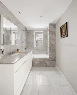 a spacious bathroom with a granite countertop sink a toilet and shower