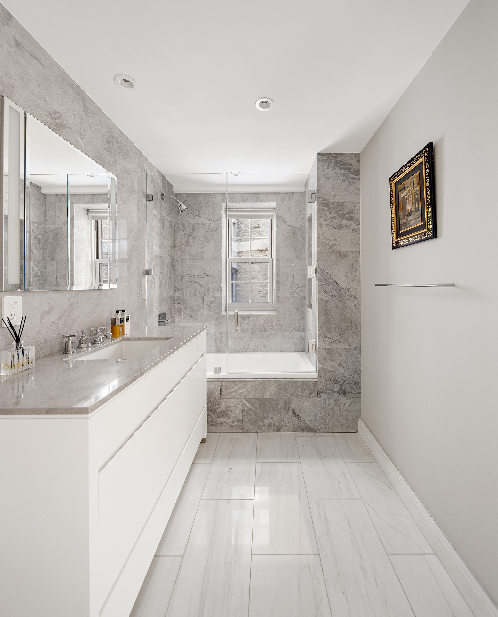 12 East 88th Street, Unit 2D Manhattan, NY 10128 - Photo 7 of 15 a spacious bathroom with a granite countertop sink a toilet and shower