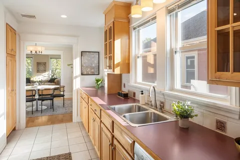 a kitchen with a sink and living room