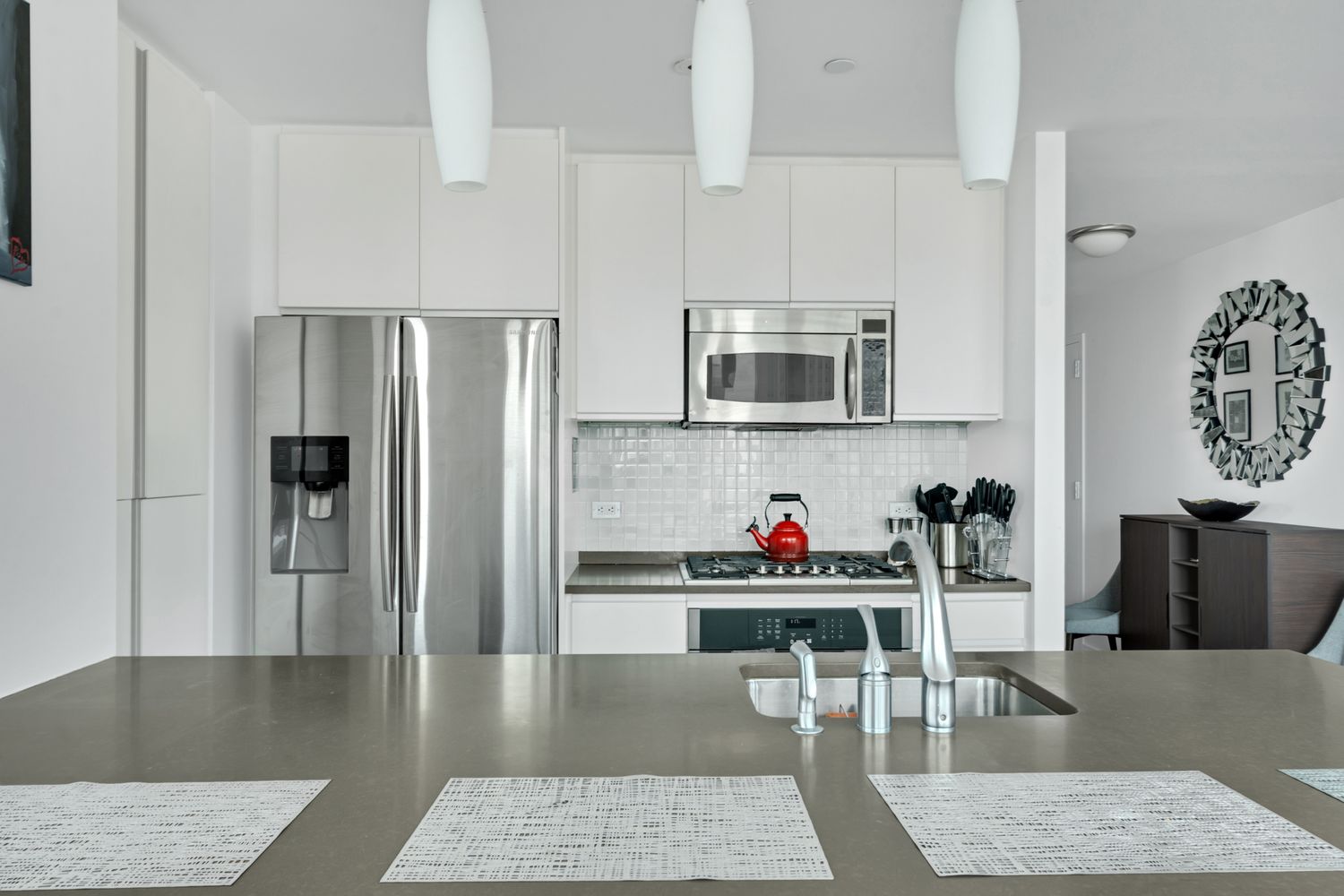 306 Gold Street, Unit 20F Brooklyn, NY 11201 - Photo 6 of 21 a kitchen with stainless steel appliances granite countertop a refrigerator a stove top oven a sink dishwasher and a dining table with wooden floor