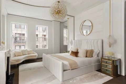 a bedroom with bed and wooden floor