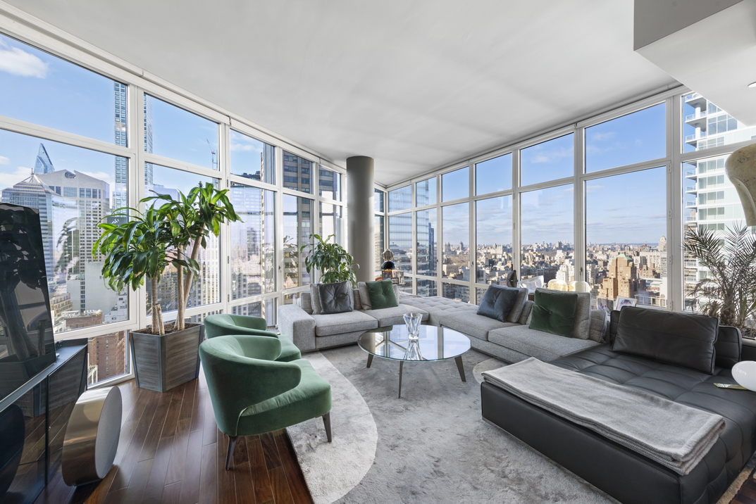 207 East 57th Street, Unit 34A Manhattan, NY 10022 - Photo 2 of 22 a living room with furniture and a large window