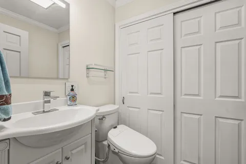 a bathroom with a sink toilet and vanity