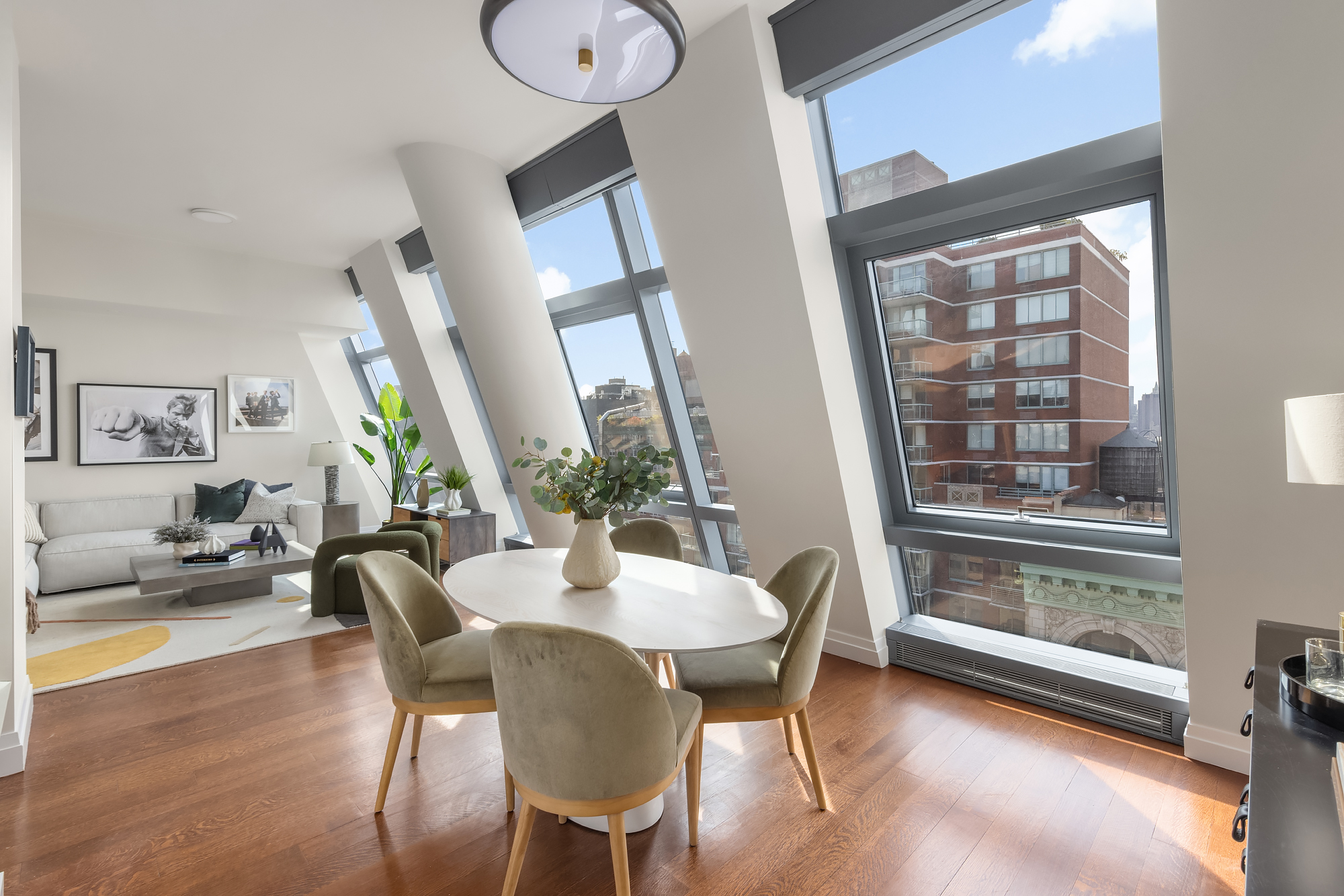 35 West 15th Street, Unit 15D Manhattan, NY 10011 - Photo 4 of 15 a view of a dining room with furniture window and wooden floor