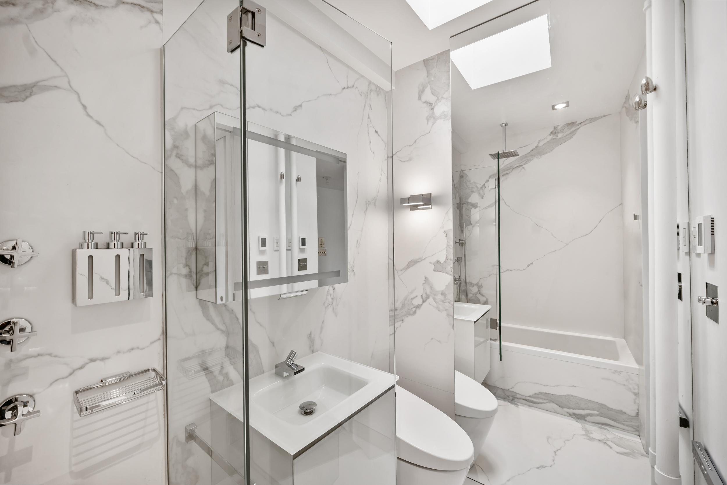 61 Horatio Street, Unit 5F Manhattan, NY 10014 - Photo 9 of 10 a bathroom with a shower sink and toilet