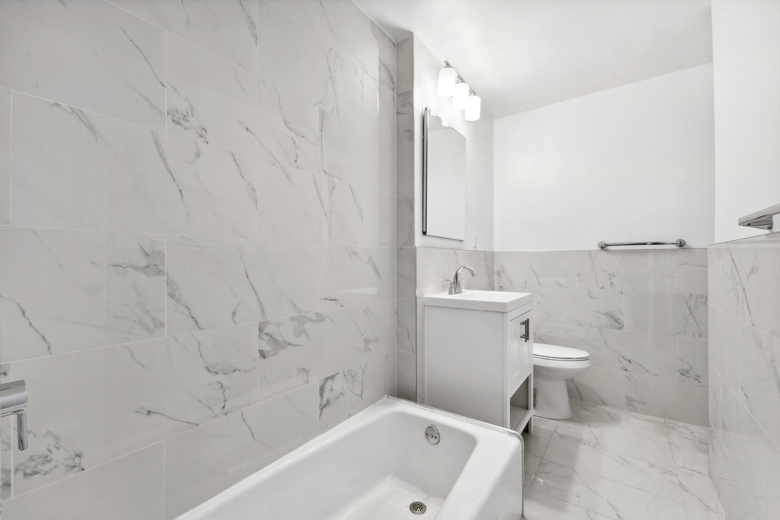 525 East 89th Street, Unit 2L Manhattan, NY 10128 - Photo 7 of 13 a bathroom with a sink a toilet and shower