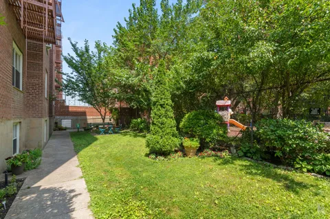 a view of a garden with a house