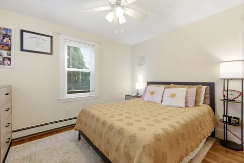 a bedroom with a bed furniture and a flat screen tv