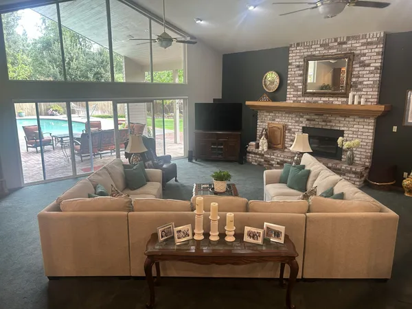 a view of a patio with a table chairs and a large tree