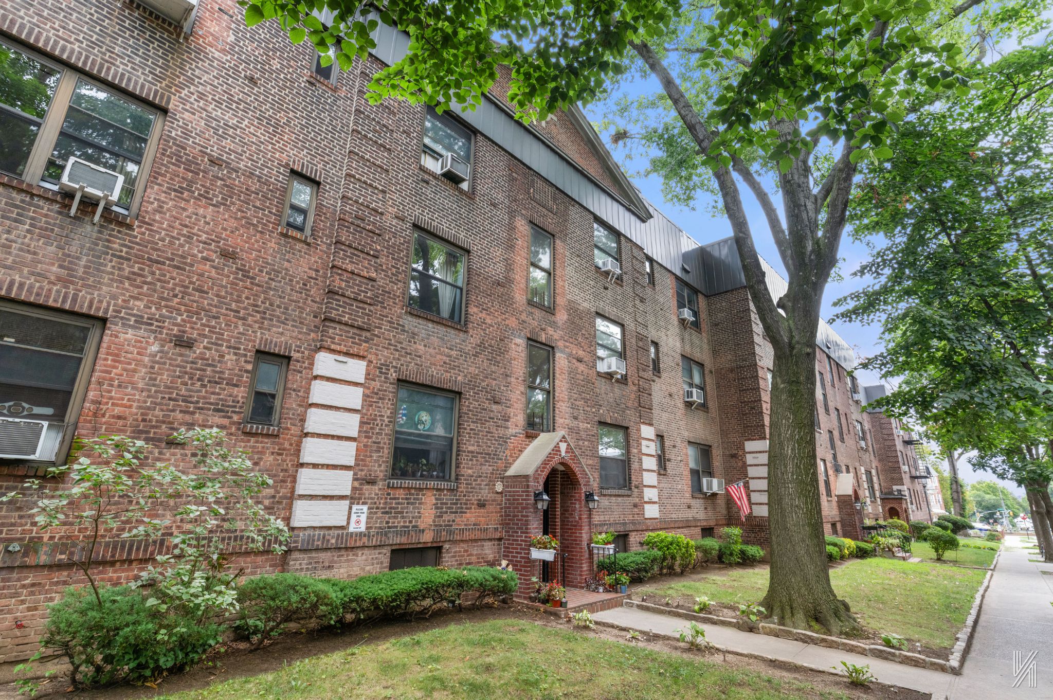 22-31 77th Street, Unit C2 Queens, NY 11370 - Photo 16 of 17 a front view of a building with garden