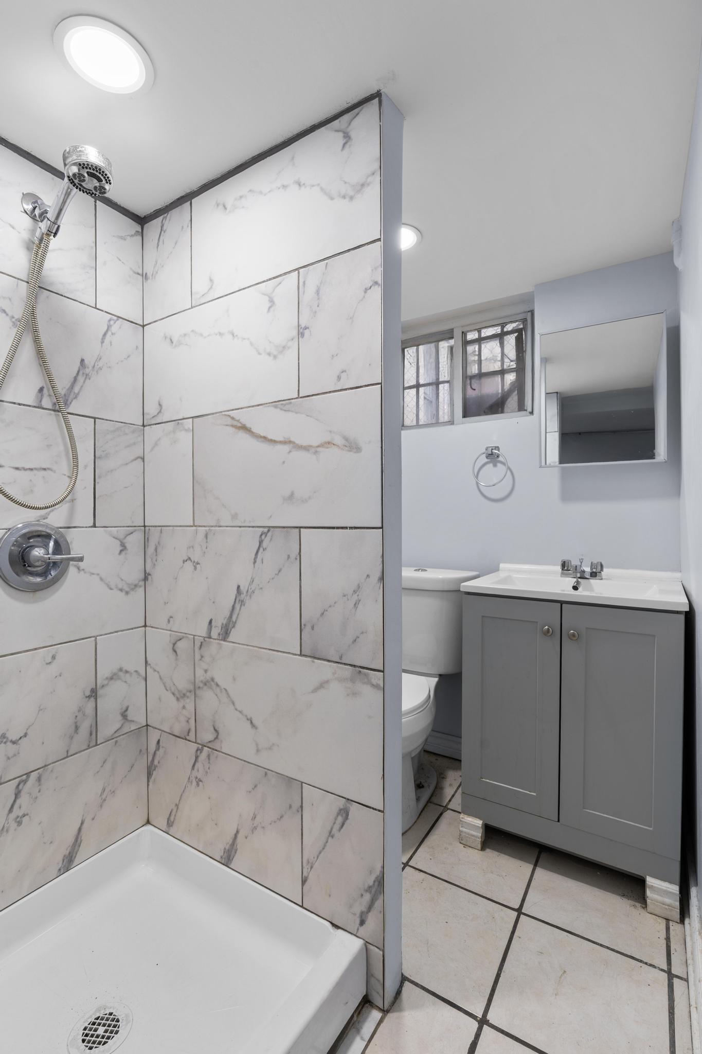 4513 Snyder Avenue Brooklyn, NY 11203 - Photo 8 of 13 a bathroom with a tub and a sink