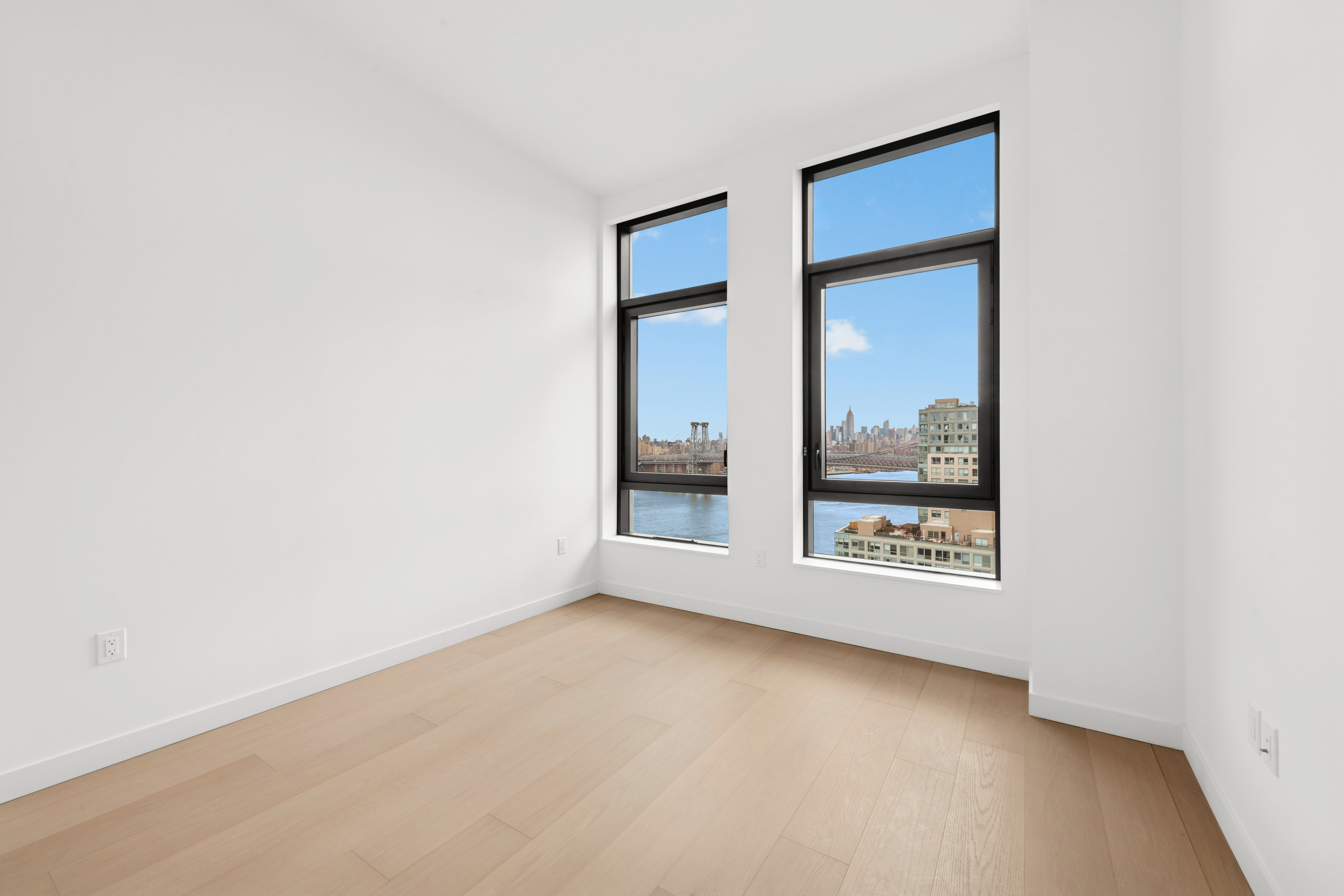 480 Kent Avenue, Unit 21C Brooklyn, NY 11249 - Photo 4 of 23 an empty room with a window