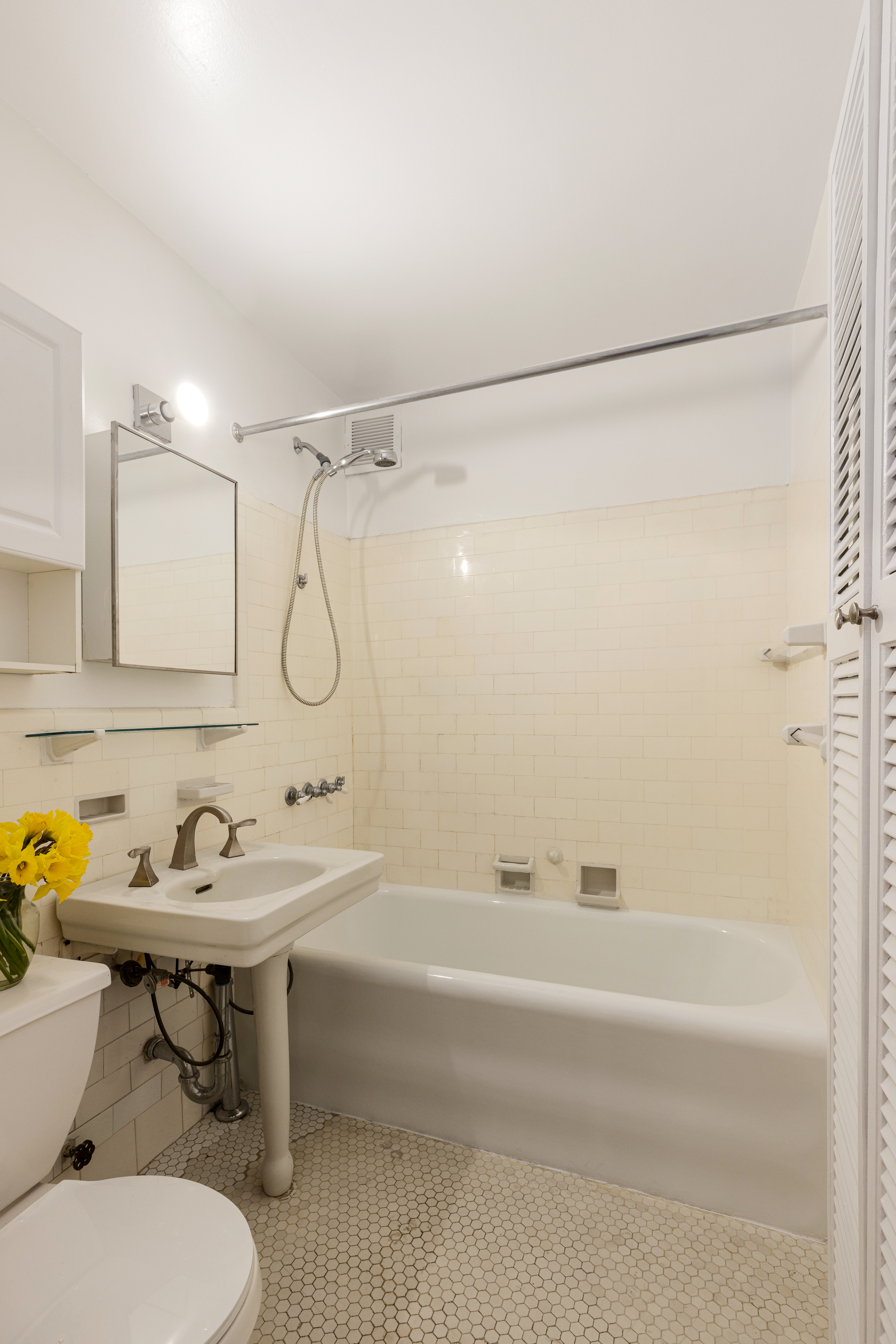 235 West 102nd Street, Unit 4E Manhattan, NY 10025 - Photo 9 of 19 a bathroom with a sink toilet and shower