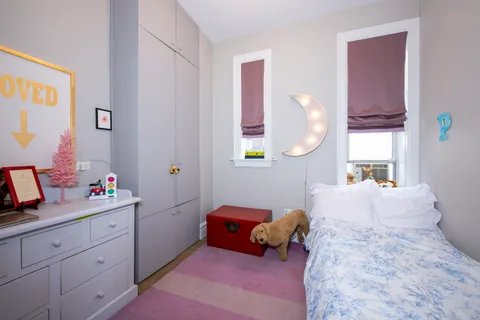 a bedroom with a bed and window