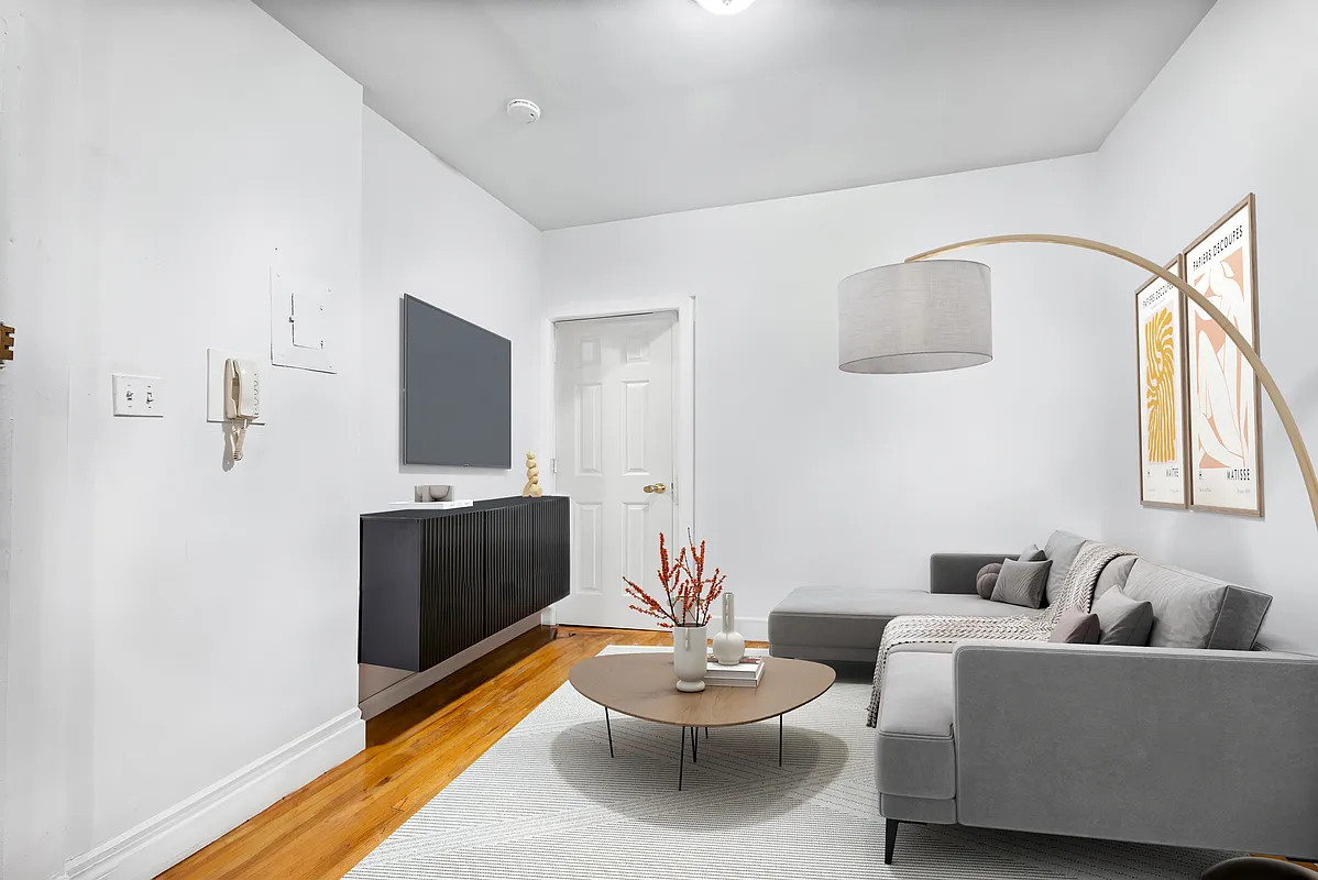 142 Sullivan Street, Unit 19 Manhattan, NY 10012 - Photo 4 of 11 a living room with furniture and a flat screen tv