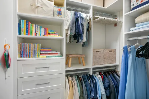 a hallway with front door and wooden floor
