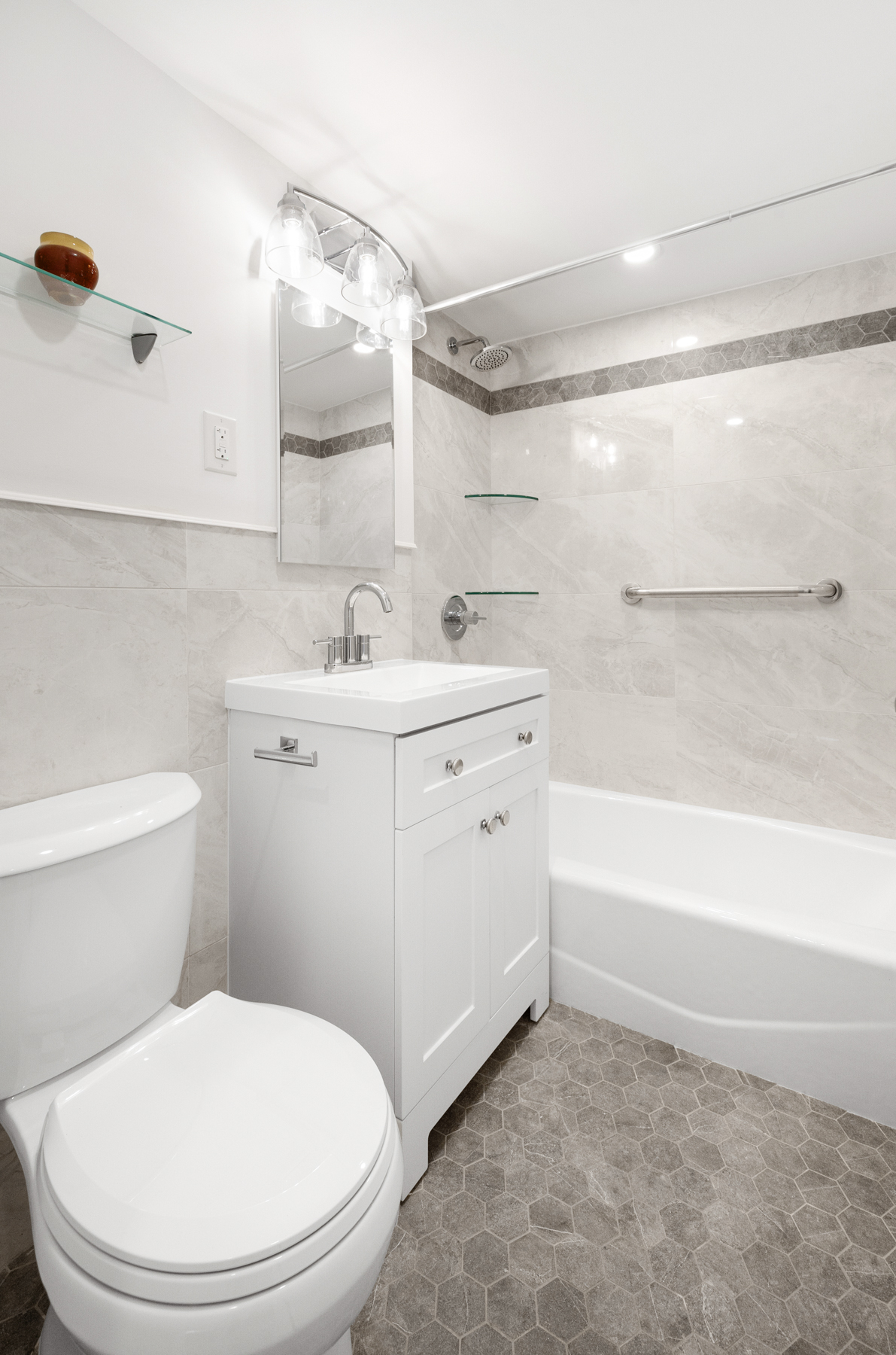 35-51 85th Street, Unit 5E Queens, NY 11372 - Photo 15 of 16 a bathroom with a sink a toilet and shower