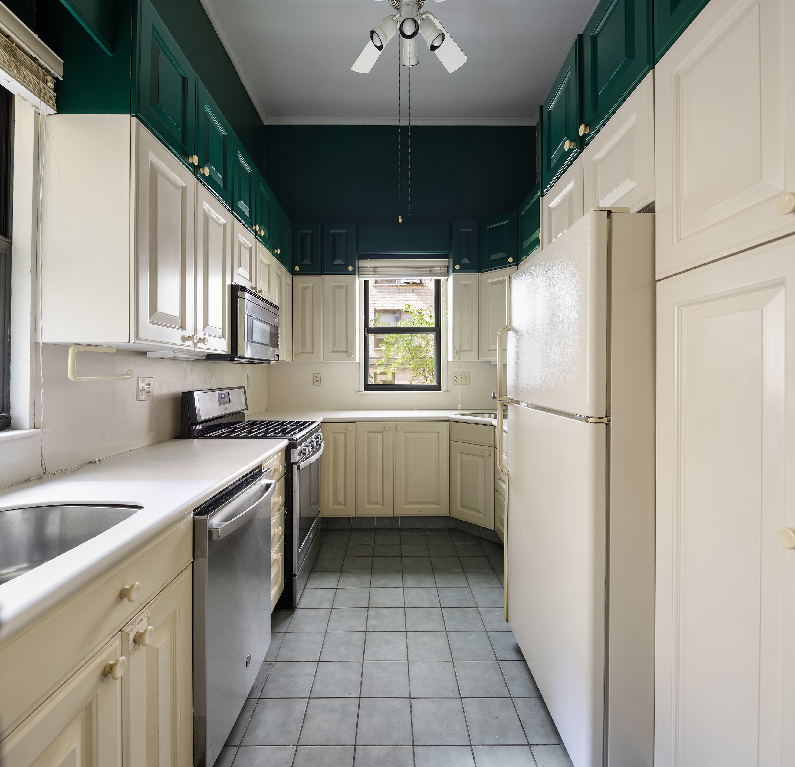 144 West 80th Street Manhattan, NY 10024 - Photo 10 of 22 a kitchen with a refrigerator a sink and a stove