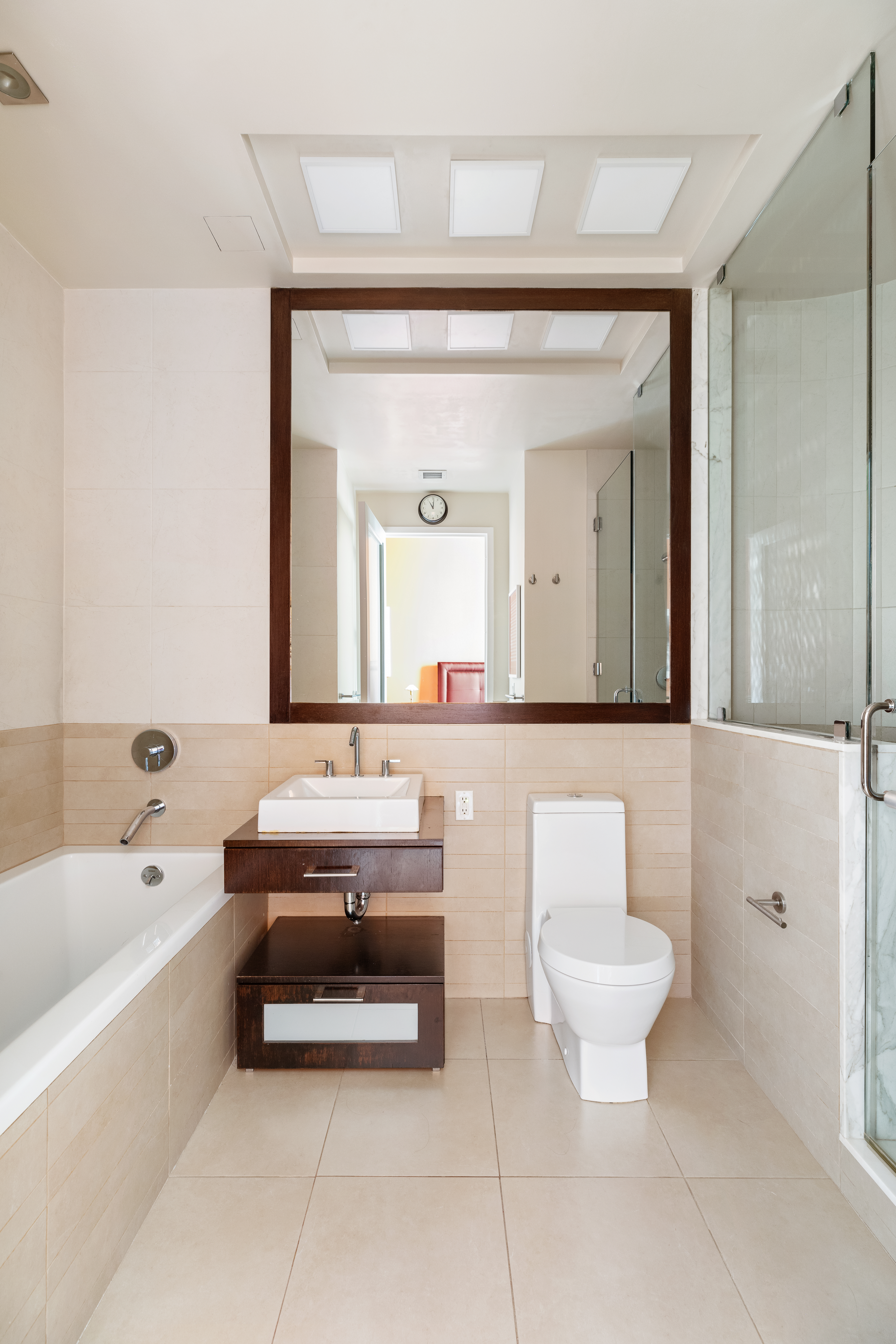 11 East 36th Street, Unit 605 Manhattan, NY 10016 - Photo 4 of 6 a bathroom with a bathtub a sink and a mirror