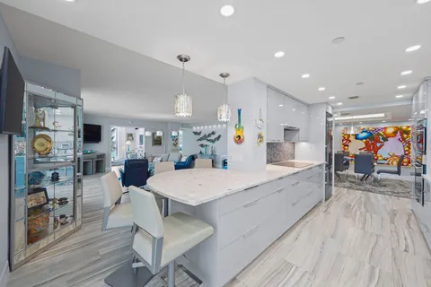 a large kitchen with stainless steel appliances lots of counter space and breakfast area
