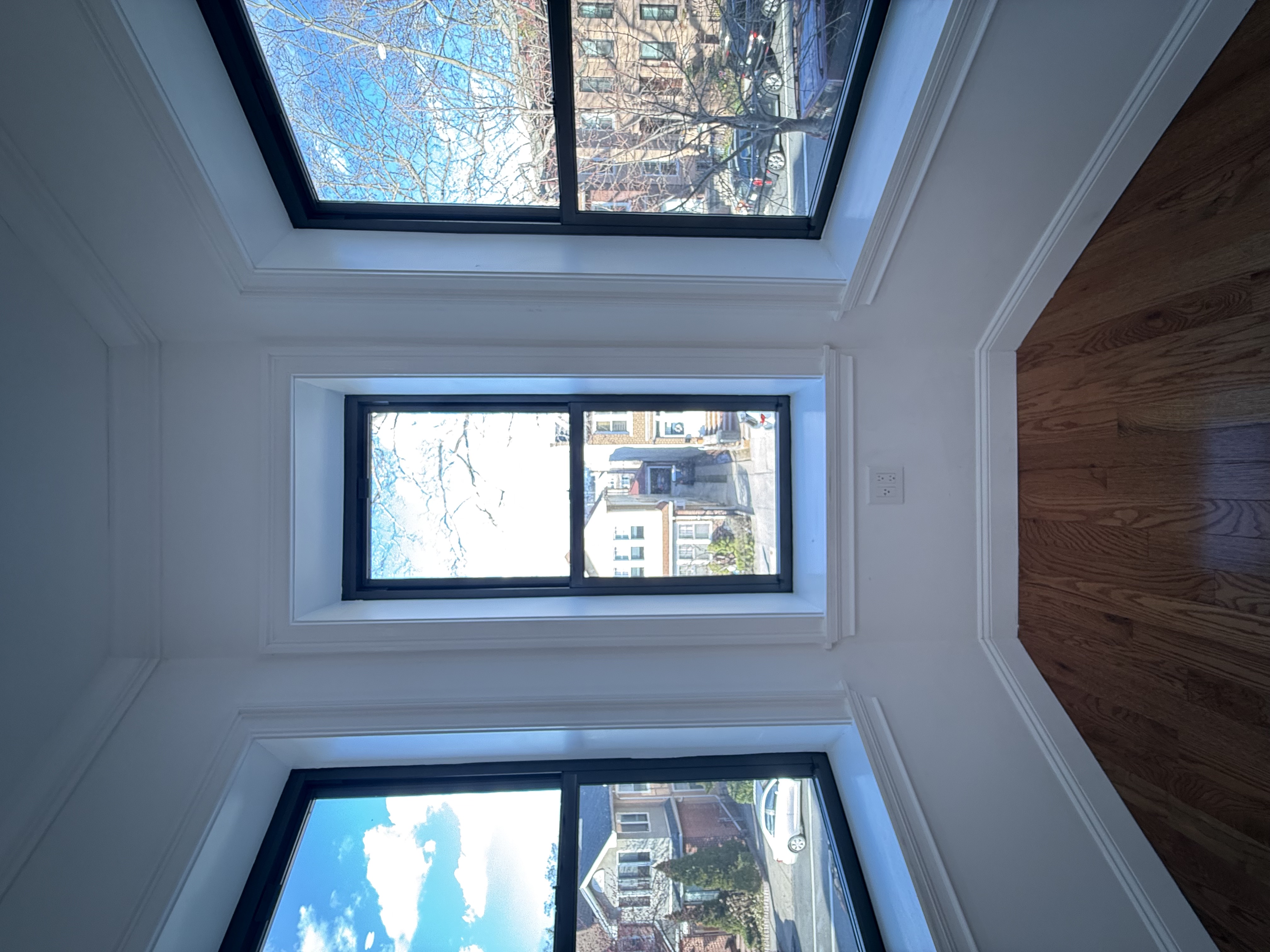 82 74th Street Brooklyn, NY 11209 - Photo 12 of 21 a view of an empty room with wooden floor and a window